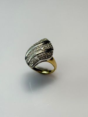 a close up of a ring with diamonds on a white surface