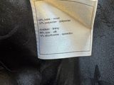 a close up of a black jacket with a label on it