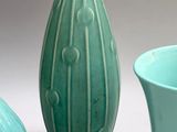 three vases sitting next to each other on a table