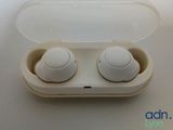 a pair of ear buds in a case on a table