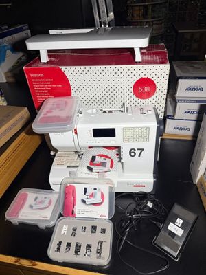 a sewing machine sitting on top of a table next to other items