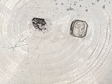 a silver plate that has a small piece of food on it