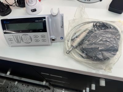 a microwave sitting on a counter with a bunch of electronics on it