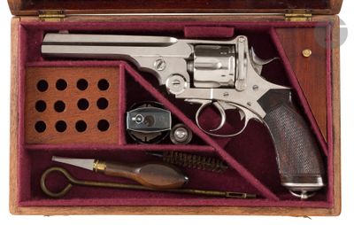 a wooden case with a gun and other items in it