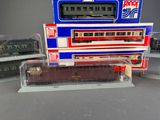 a model train on display in front of a pepsi machine