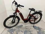 a red bike that is parked in a room