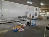 an image of a factory with a large machine in the middle of the room