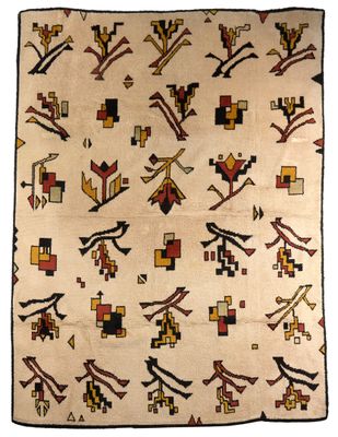 un vieux tapis navajo orné de motifs géométriques sur fond blanc