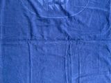 a blue towel with a boat on it sitting on the floor
