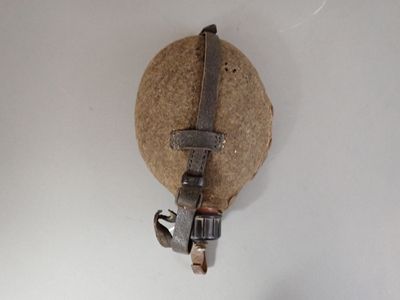 a wrenet hanging on the wall next to a piece of paper