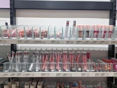 a lot of makeup products on the shelves in the store