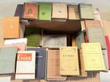 many books stacked on top of each other in a box