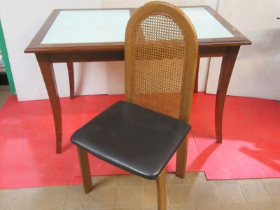 a chair that is next to a table with a glass top