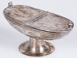 a silver bowl with a lid that has a design on it
