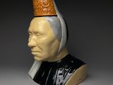 a ceramic bust of a man with a crown on his head