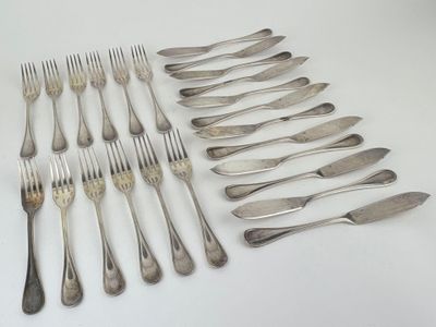 many forks and spoons laid out on the table