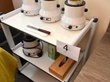 a small table with a bunch of pots and pans on it