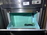 an ice maker that is sitting in the middle of a counter
