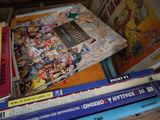 many children ' s books stacked on top of each other