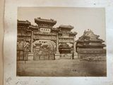 an old photo of an asian gate in the middle of the day