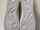 a pair of white shoes sitting on top of a box