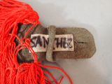 a red string with a tag that says san he on it