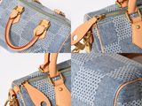 two pieces of denim and leather luggage sitting on top of each other