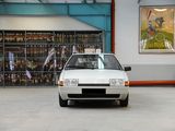 a white car parked in a parking lot in front of a store