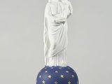 a statue of a woman holding a child on top of a blue ball