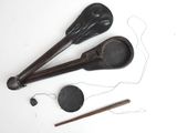 two wooden spoons and a pair of scissors on a white surface