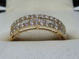 a close up of a diamond ring on a white cloth
