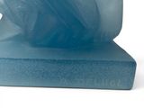 a blue soap that is sitting on top of a block of soap