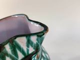 two vases sitting next to each other on a table