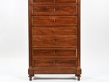 a wooden chest of drawers with four drawers on one side and three drawers on the other