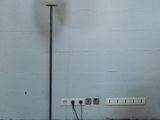a lamp that is on a stand in the corner of a room