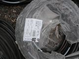 a plastic bag with a label on it sitting next to a pile of hoses