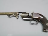 an old gun with a wooden handle on a table