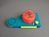 a small plastic object with a plastic cup on top of it