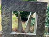 a stone sculpture that is sitting in the middle of the yard