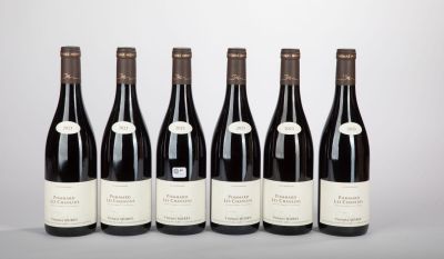 six bottles of wine lined up in a row on a table