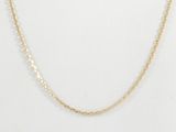 a gold chain necklace with a small diamond on it