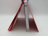 a folded book with a red bookmark on top of it