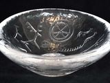 a glass bowl with a design on it on a black background
