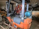 a forklift that is parked in a garage