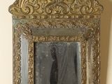 a mirror hanging on the wall with a person in it