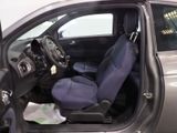 the interior of a car with a blue seat and steering wheel
