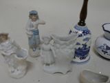 several figurines are sitting on a table next to a vase