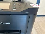 a canon printer that is sitting on the floor
