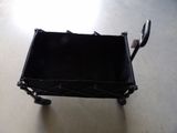 a small black cart with a handle on the floor