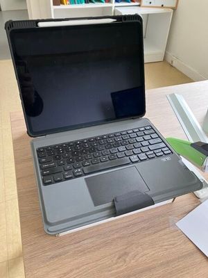 a laptop computer sitting on top of a wooden desk